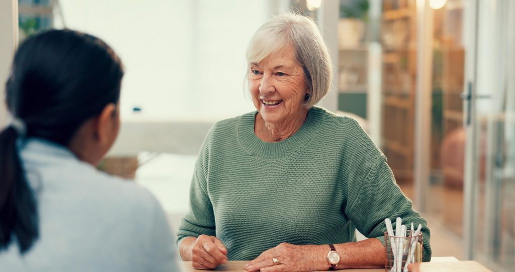 Meeting, talking or psychology consulting old woman for therapy, mental health or support in retirement. Happy elderly person talking, psychologist listening or therapist with help for senior patient