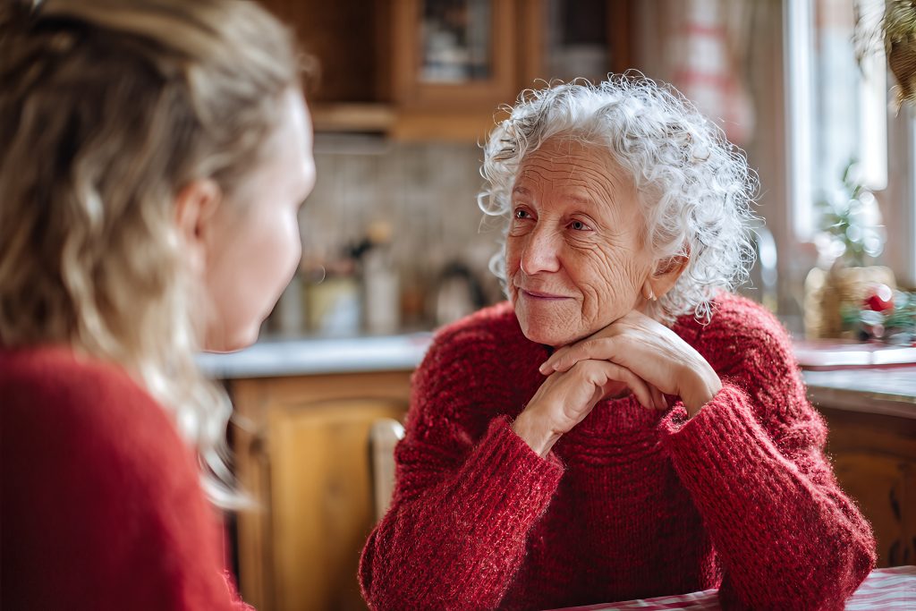 Warm intergenerational moment: smiling senior woman in cozy red